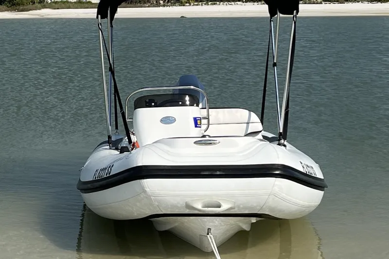 Slide: The Image of 2020 Walker Bay Generation 360 boat anchored on a sandy beach. - 3