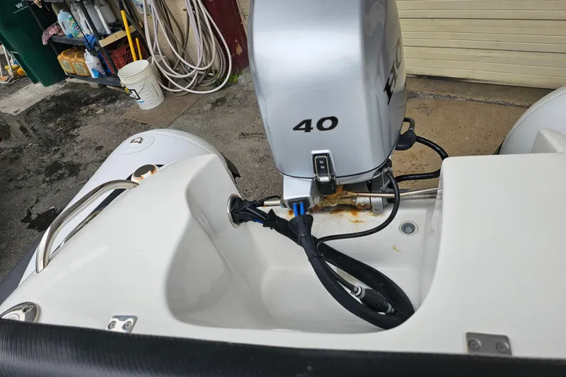 Slide: The Image of 2020 Walker Bay Generation 360 boat with a 40 HP outboard motor in a garage setting. - 30