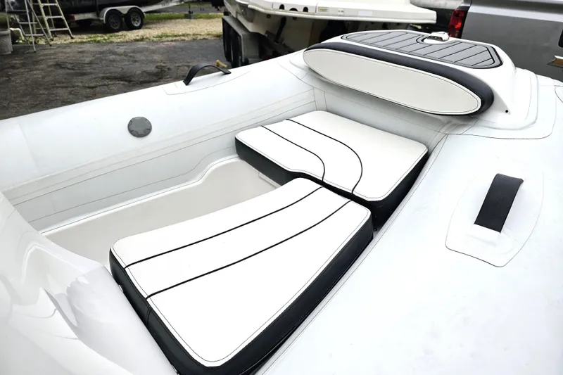 Slide: The Image of 2020 Walker Bay Generation 360 boat interior with white cushioned seating. - 34