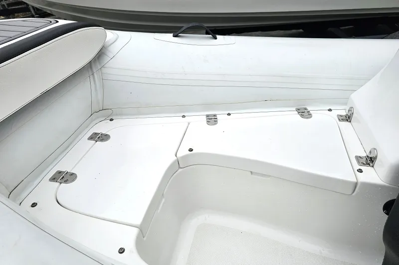 Slide: The Image of 2020 Walker Bay Generation 360 boat interior with white seating and storage compartments. - 36