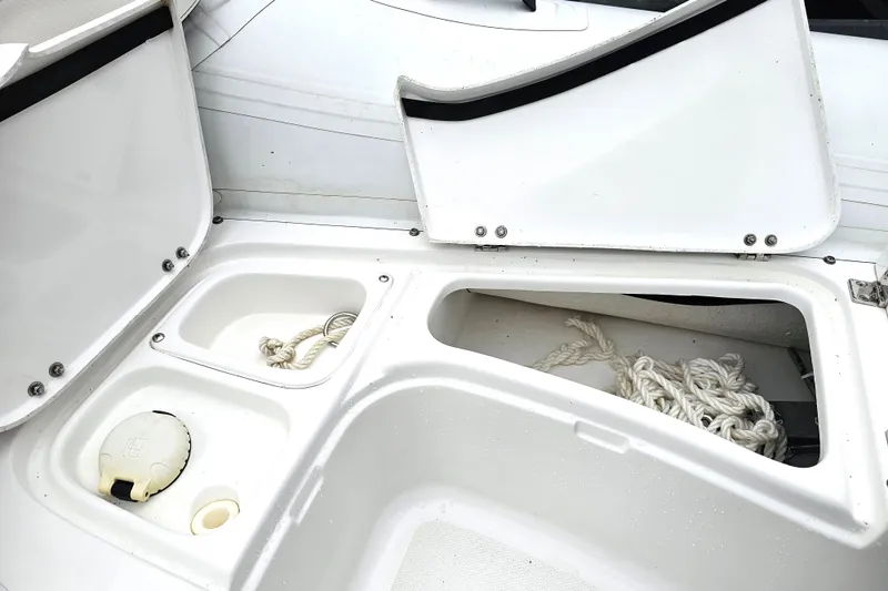 Slide: The Image of Open storage compartments on a 2020 Walker Bay Generation 360 boat, featuring ropes and accessories. - 37