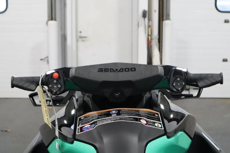 Slide: The Image of 2026 Sea-Doo GTI SE 170 handlebars and controls in a garage setting. - 11