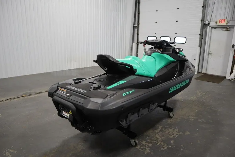 Slide: The Image of 2026 Sea-Doo GTI SE 170 jet ski in a garage, featuring a sleek design and vibrant colors. - 5