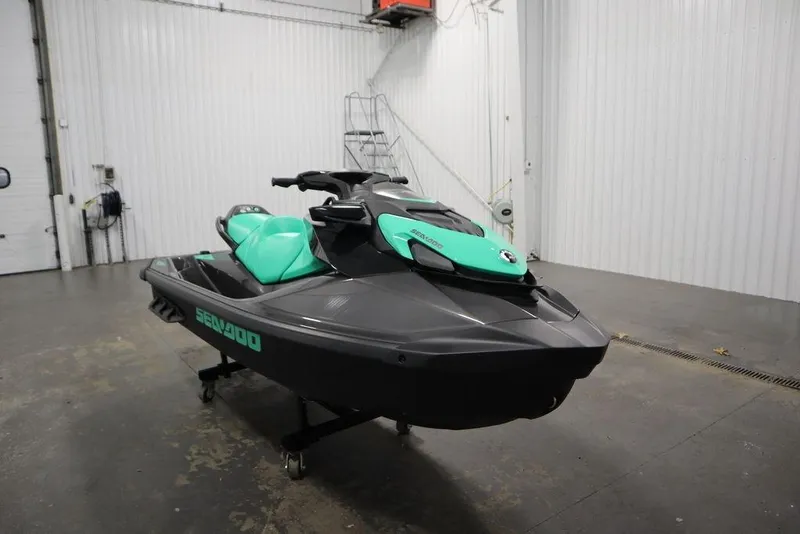 Slide: The Image of 2026 Sea-Doo GTI SE 170 jet ski in a garage, featuring a sleek black and teal design. - 6