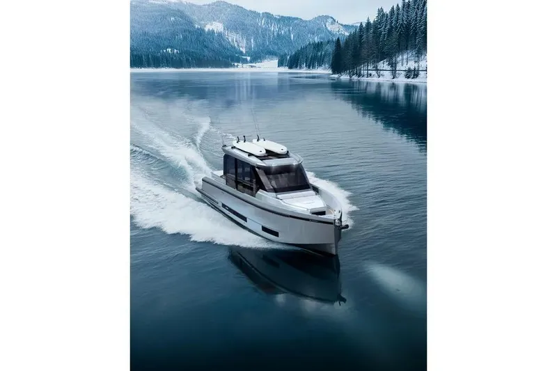 Slide: The Image of De Antonio Yachts D36 CABIN 2026 on a serene winter lake. - 4