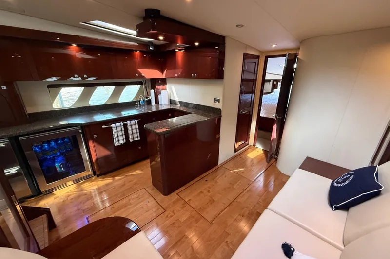 Slide: The Image of Luxurious interior of 2008 Sea Ray 550 Sundancer yacht with modern kitchen and seating area. - 11