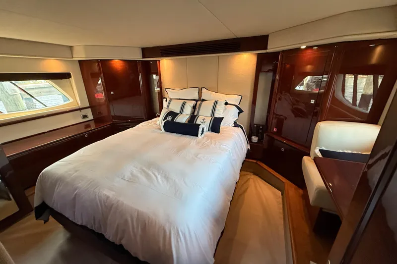 Slide: The Image of Luxurious bedroom interior of 2008 Sea Ray 550 Sundancer yacht with elegant wood finishes. - 13