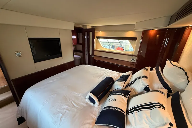 Slide: The Image of Luxurious bedroom interior of 2008 Sea Ray 550 Sundancer yacht with elegant bedding and window view. - 14