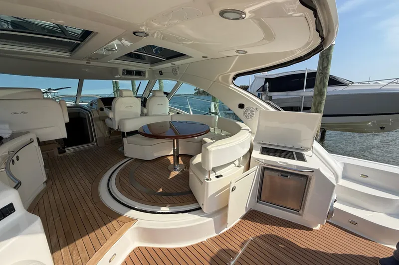 Slide: The Image of Luxurious 2008 Sea Ray 550 Sundancer yacht interior with elegant seating and wooden flooring. - 3