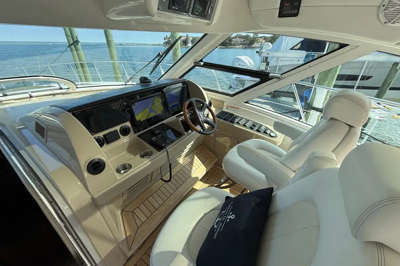 Slide: The Image of Luxurious helm of 2008 Sea Ray 550 Sundancer yacht with navigation screens and plush seating. - 4