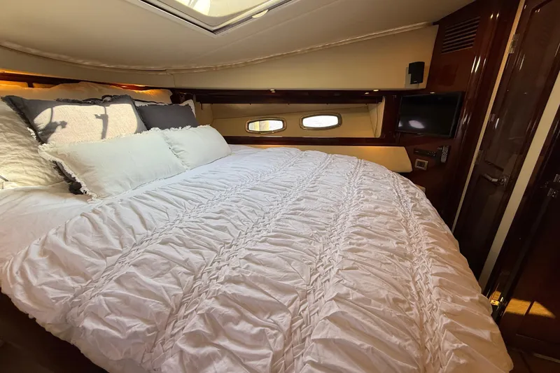 Slide: The Image of Luxurious bedroom interior of 2008 Sea Ray 550 Sundancer yacht with plush bedding. - 8