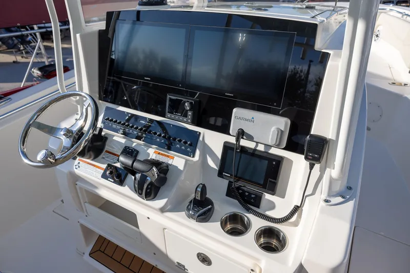 Slide: The Image of 2022 Cobia 320 Center Console helm with Garmin displays and controls. - 15