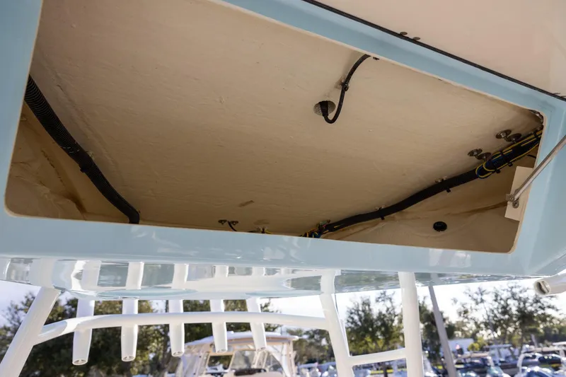 Slide: The Image of 2022 Cobia 320 Center Console boat wiring and storage compartment view. - 17