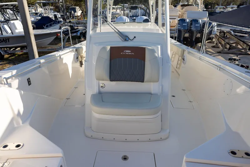 Slide: The Image of 2022 Cobia 320 Center Console boat interior with seating and console view. - 22
