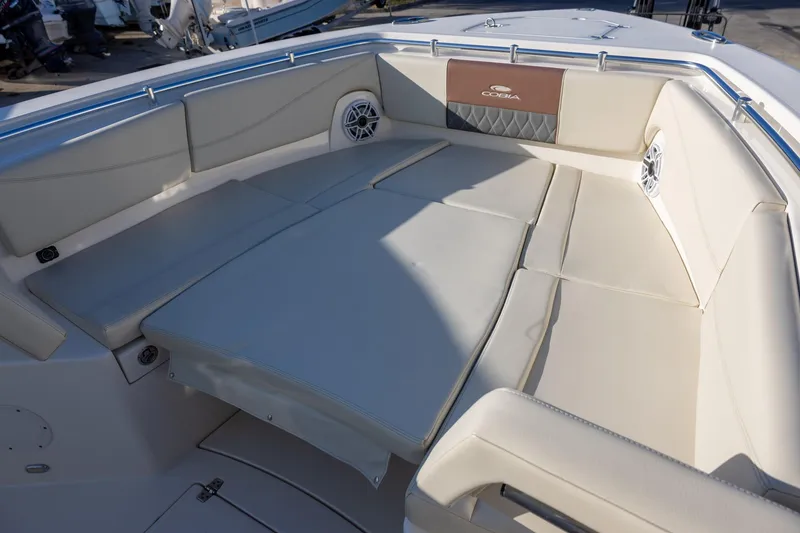 Slide: The Image of 2022 Cobia 320 Center Console boat with spacious seating area and cushioned deck. - 25