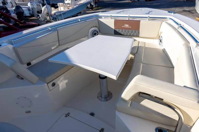 Slide: The Image of 2022 Cobia 320 Center Console boat interior with seating and table. - 26