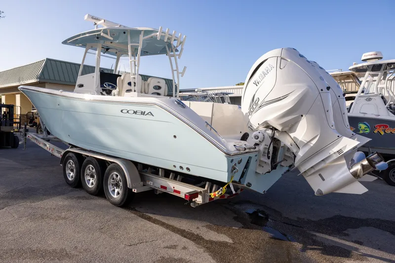Slide: The Image of 2022 Cobia 320 Center Console boat on trailer with Yamaha outboard engines. - 3