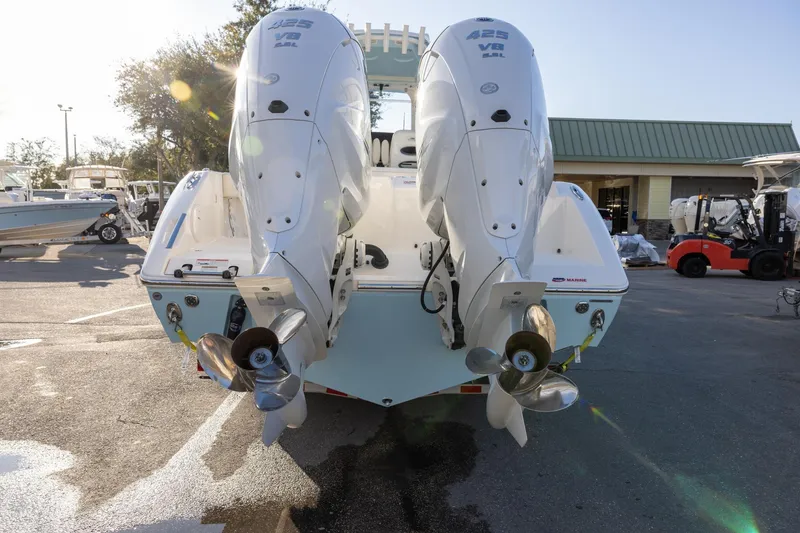 Slide: The Image of 2022 Cobia 320 Center Console with twin 425 V8 engines, parked outdoors. - 5
