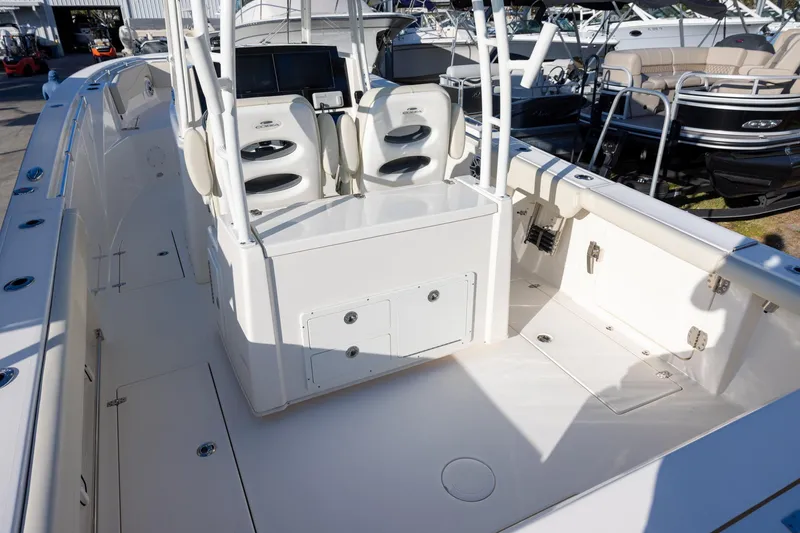 Slide: The Image of 2022 Cobia 320 Center Console boat interior with seating and control panel. - 6