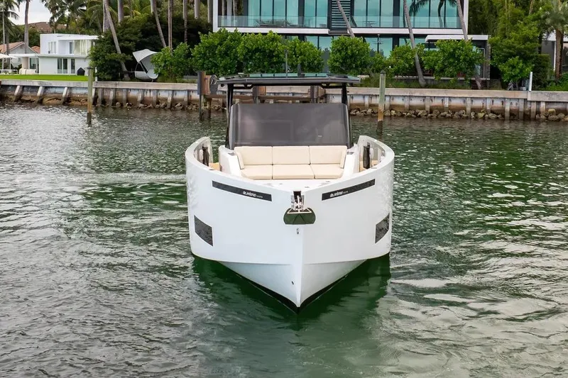 Slide: The Image of De Antonio Yachts D42 2026 on water near modern villa. - 2