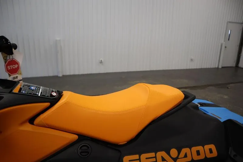 Slide: The Image of 2025 Sea-Doo Spark Trixx, orange seat, indoor view. - 15