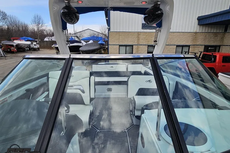 Slide: The Image of 2017 Monterey 298SS Super Sport boat interior with seating and speakers, parked outdoors. - 102