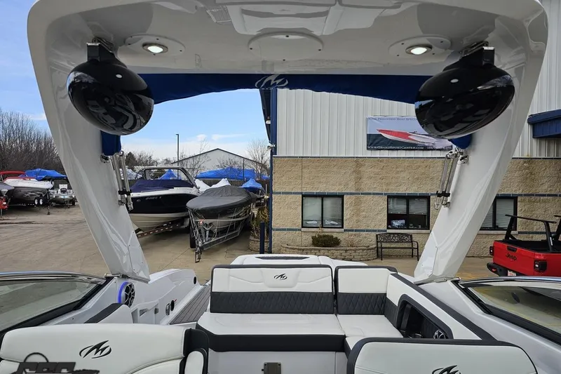 Slide: The Image of 2017 Monterey 298SS Super Sport boat interior with seating and speakers, docked near other boats. - 108