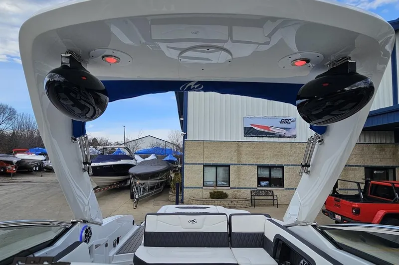 Slide: The Image of 2017 Monterey 298SS Super Sport boat interior with speakers and seating, docked near showroom. - 109