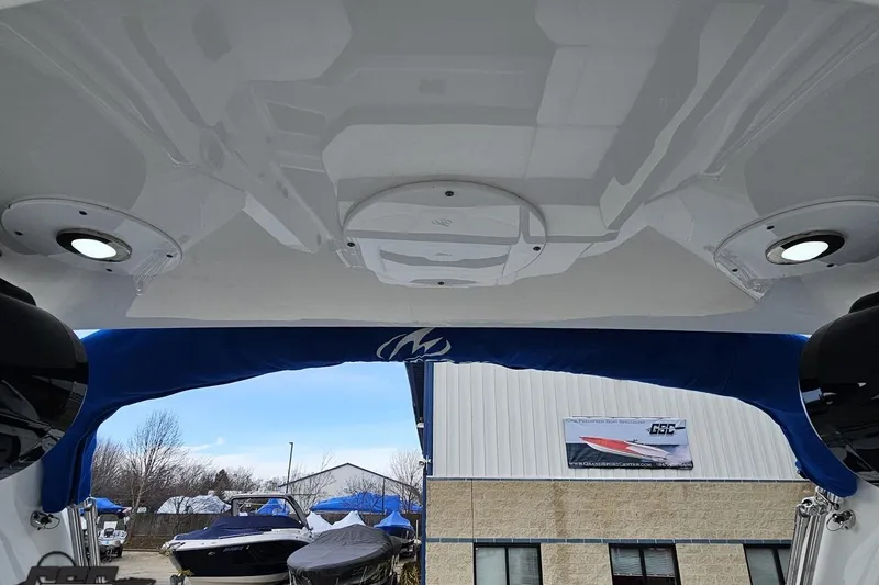 Slide: The Image of 2017 Monterey 298SS Super Sport boat interior with blue canopy and overhead lights. - 110