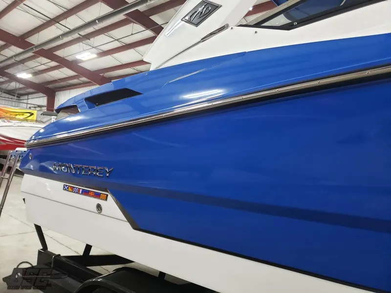 Slide: The Image of 2017 Monterey 298SS Super Sport boat in blue in a warehouse. - 25