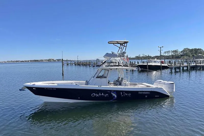 The Image of 2013 Everglades 355 Center Console boat docked on calm water. - 1