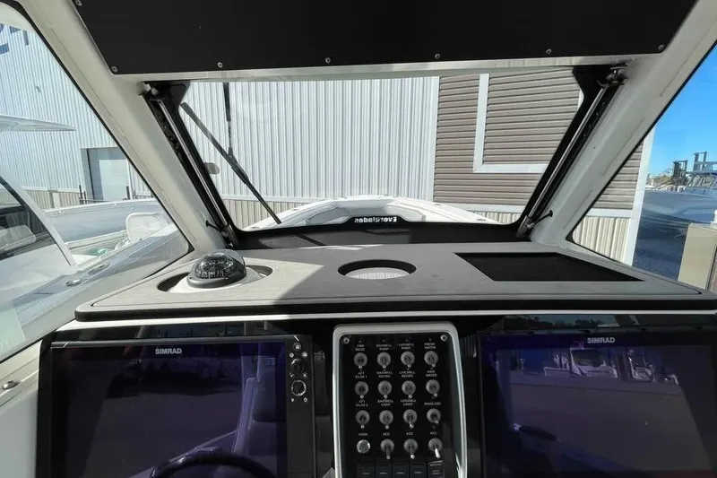 Slide: The Image of 2013 Everglades 355 Center Console helm with Simrad displays and compass. - 8
