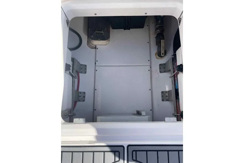 Slide: The Image of 2013 Everglades 355 Center Console interior compartment, showcasing storage and mechanical components. - 9
