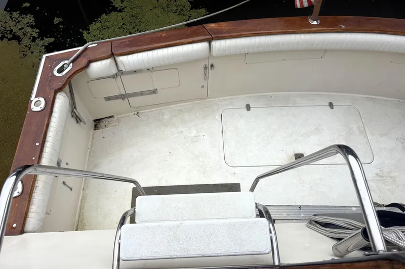 Slide: The Image of 1987 Californian 53 Cockpit Motor Yacht deck with wooden trim and metal railings. - 10