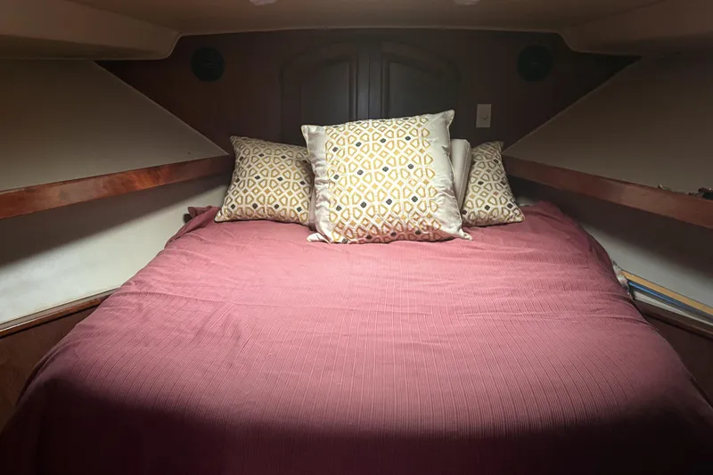 Slide: The Image of Cozy cabin bedroom in 1987 Californian 53 Cockpit Motor Yacht with patterned pillows. - 7