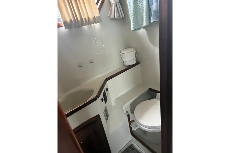 Slide: The Image of Bathroom interior of 1987 Californian 53 Cockpit Motor Yacht, featuring compact design and amenities. - 8