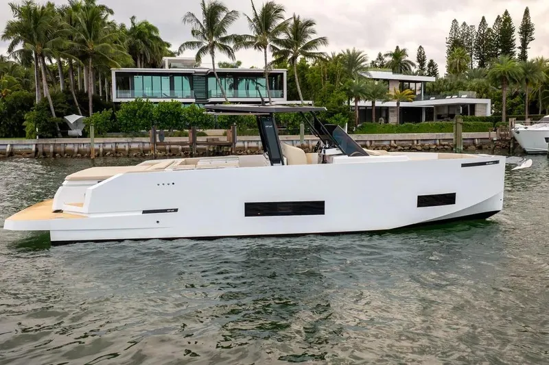 The Image of De Antonio Yachts D42 2026 near modern villa and palm trees. - 1