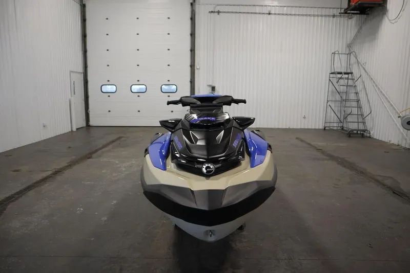 Slide: The Image of 2025 Sea-Doo Wake Pro 230 jet ski in a spacious indoor garage. - 3
