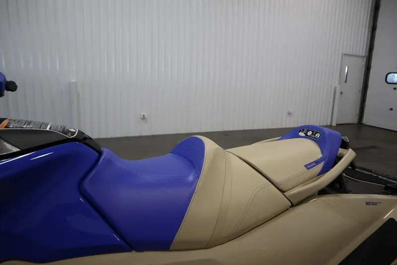 Slide: The Image of 2026 Sea-Doo Wake Pro 230 jet ski with blue and beige seating in a garage. - 16