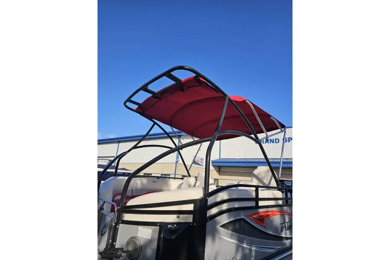 Slide: The Image of 2019 JC Tritoon Neptoon 25 Sport SL with red canopy and sleek design. - 10