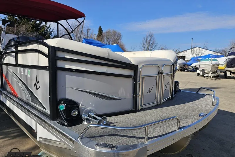 Slide: The Image of 2019 JC Tritoon Neptoon 25 Sport SL pontoon boat with sleek design, docked outdoors. - 13