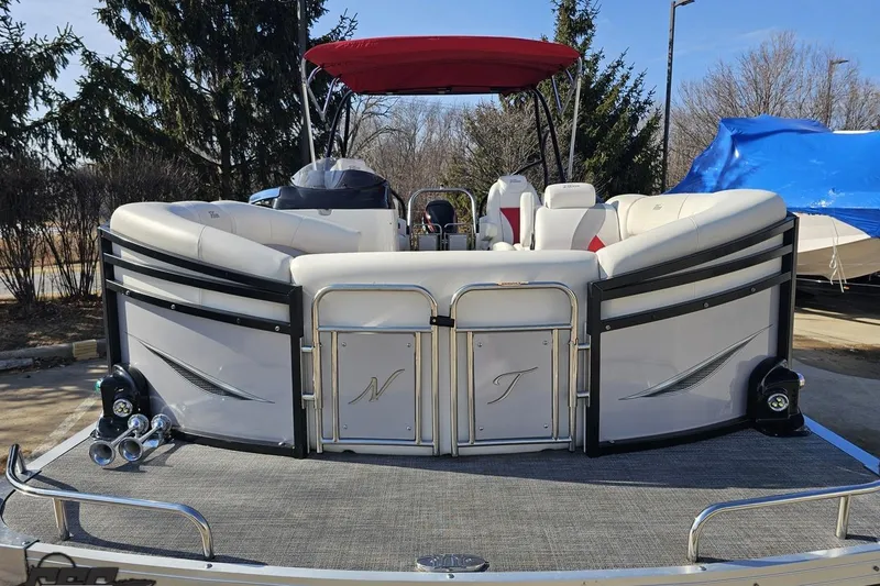 Slide: The Image of 2019 JC Tritoon Neptoon 25 Sport SL pontoon boat with red canopy, docked outdoors. - 16