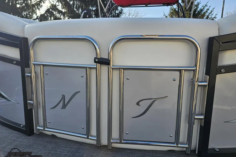 Slide: The Image of 2019 JC Tritoon Neptoon 25 Sport SL boat gate with chrome accents and logo. - 20