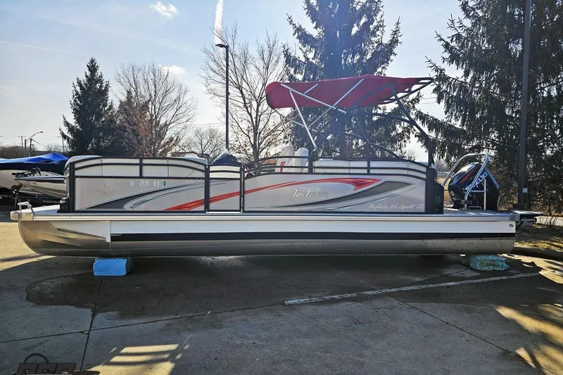 Slide: The Image of 2019 JC Tritoon Neptoon 25 Sport SL pontoon boat with red canopy, parked outdoors. - 27