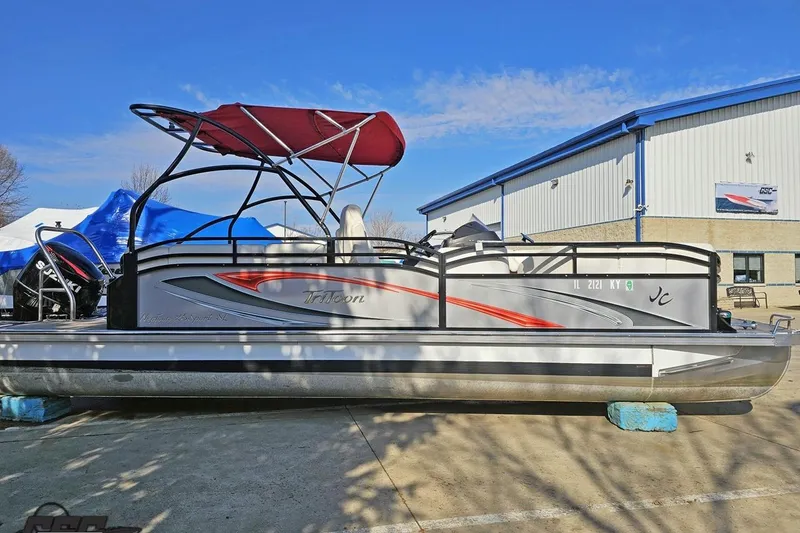 Slide: The Image of 2019 JC Tritoon Neptoon 25 Sport SL pontoon boat with red canopy, parked outdoors. - 3