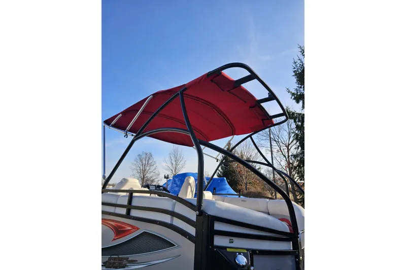 Slide: The Image of 2019 JC Tritoon Neptoon 25 Sport SL with red canopy and sleek design. - 32