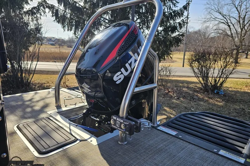 Slide: The Image of 2019 JC Tritoon Neptoon 25 Sport SL with Suzuki outboard motor, parked outdoors. - 35