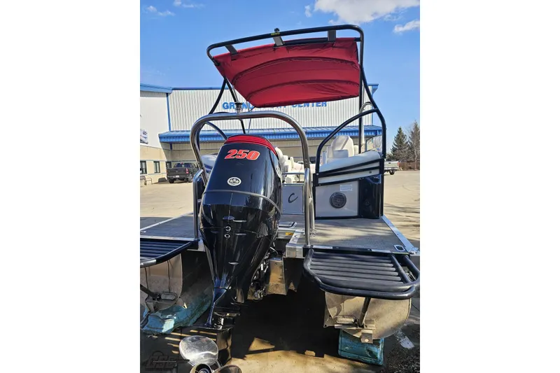 Slide: The Image of 2019 JC Tritoon Neptoon 25 Sport SL with powerful 250 engine, docked outdoors. - 40