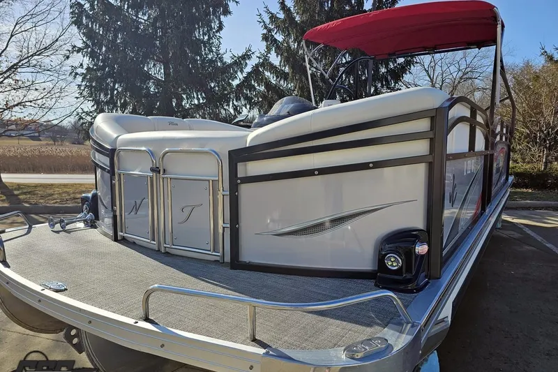 Slide: The Image of 2019 JC Tritoon Neptoon 25 Sport SL pontoon boat with red canopy, parked outdoors. - 21