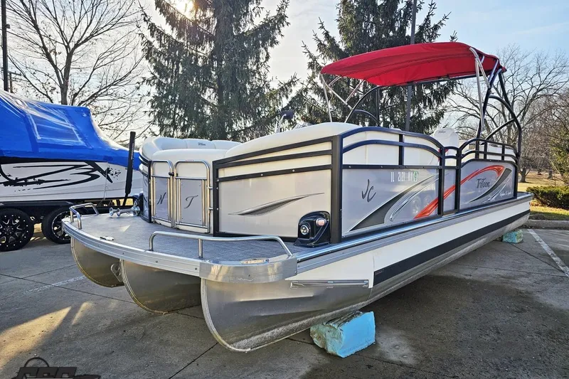 Slide: The Image of 2019 JC Tritoon Neptoon 25 Sport SL pontoon boat with red canopy in a sunny outdoor setting. - 24